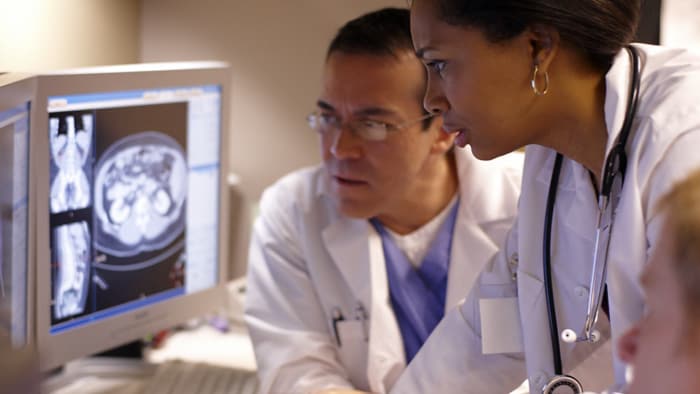 Two doctors looking at medical image on computer