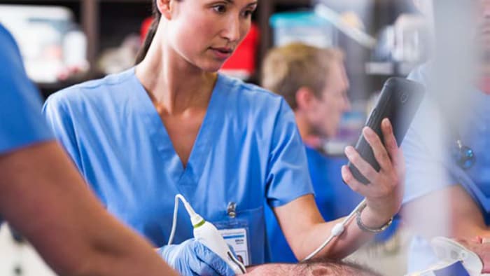 Healthcare professional using handheld ultrasound